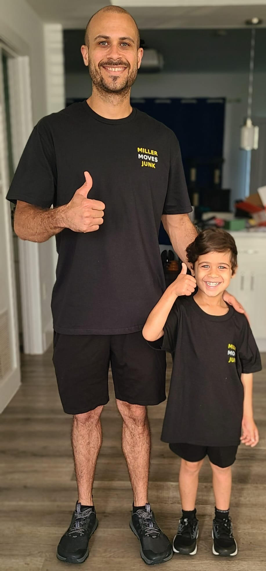 Isaac and his son – Miller Moves Junk, family-owned in Edgewater MD Isaac Miller and son giving a thumbs up while wearing Miller Moves Junk shirts — family-owned junk removal business in Edgewater, Maryland