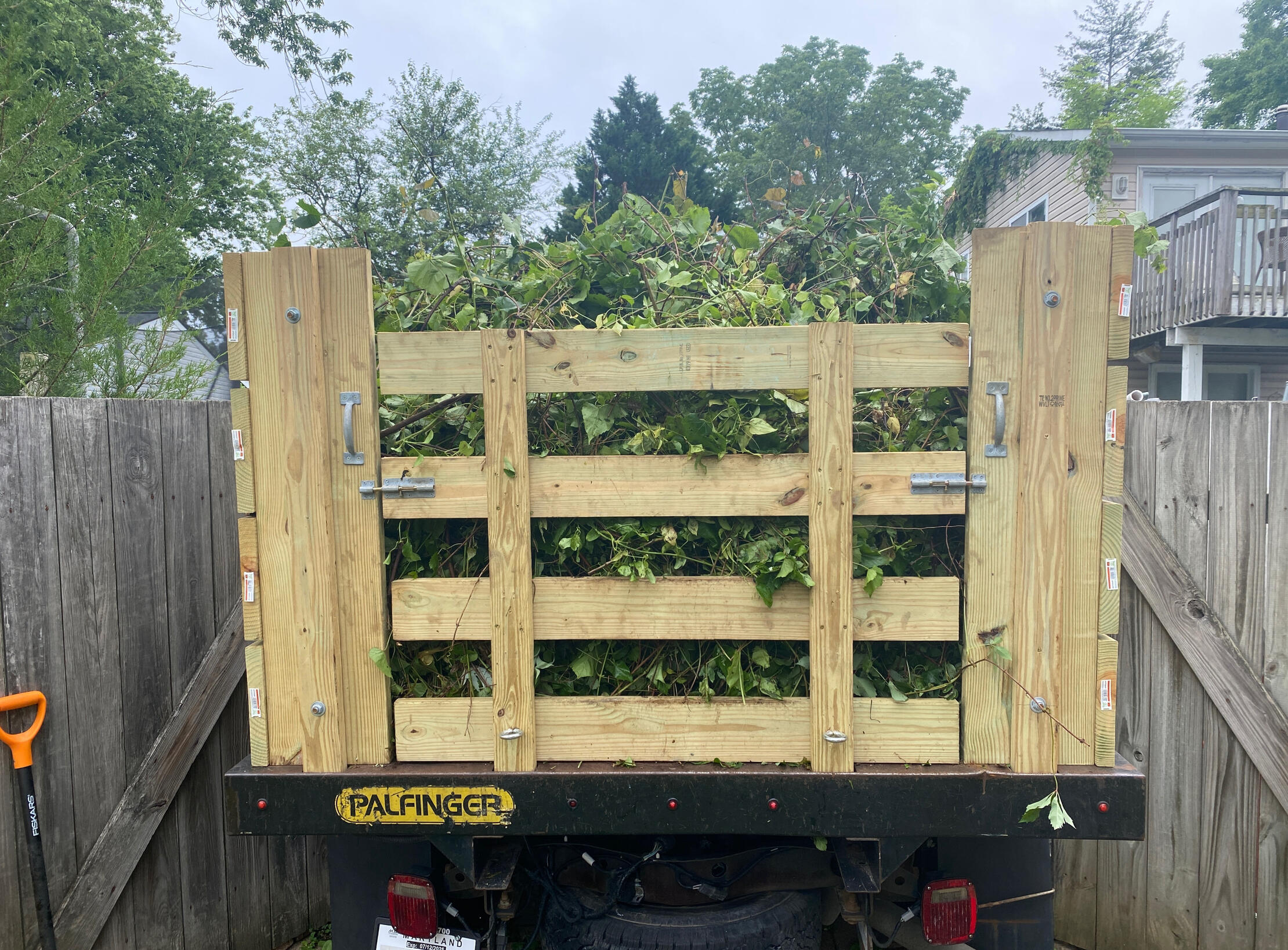 Yard debris removal by Miller Moves Junk in Edgewater, MD Miller Moves Junk truck loaded with yard waste and branches in Edgewater, Maryland after backyard cleanup